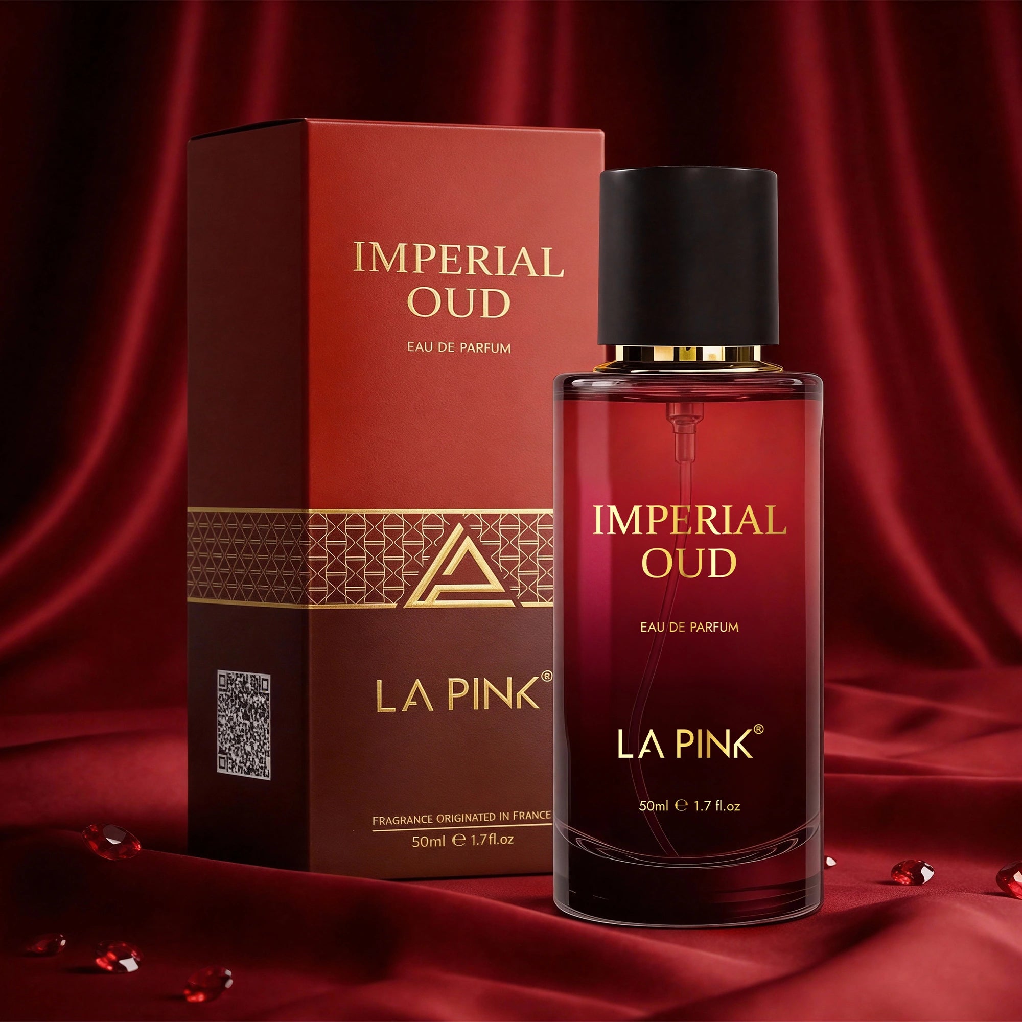 La Pink Imperial Oud perfume bottle and packaging on a red fabric background