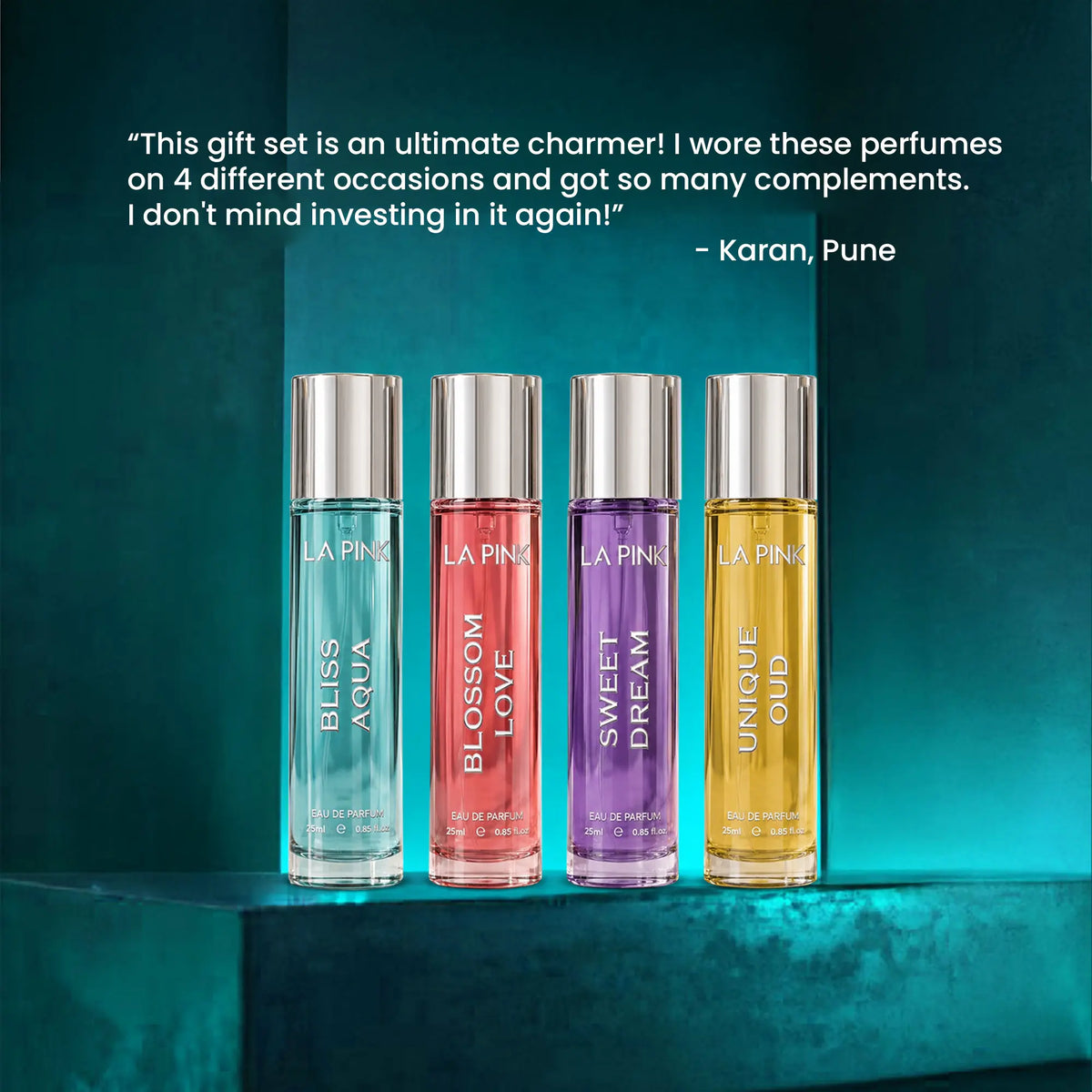 Four LA PINK perfume bottles in different colors are lined up on a dark teal pedestal with a customer testimonial quote above them. The bottles are labeled Bliss Aqua, Blossom Love, Sweet Dream, and Unique Oud.