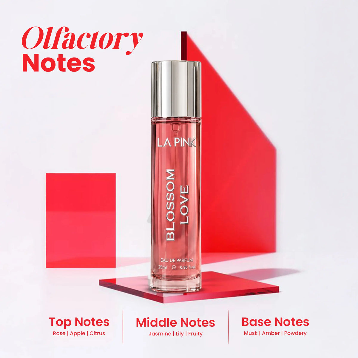 A bottle of LA PINK Blossom Love Eau de Parfum stands on a glossy red platform against a white background with red graphic shapes. Large red text at the top reads &