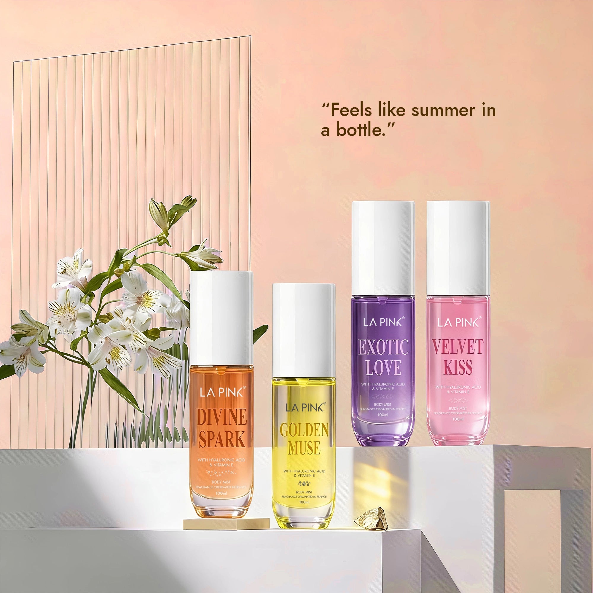 Four bottles of La Pink perfume with flowers on a light background