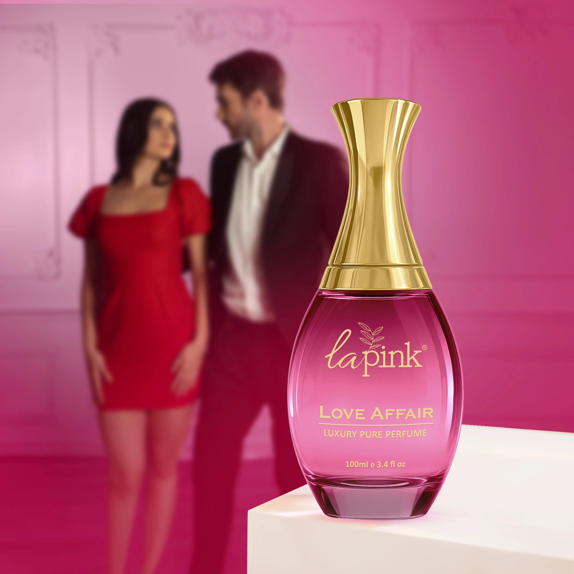 La Pink Love Affair perfume bottle with a blurred couple in the background