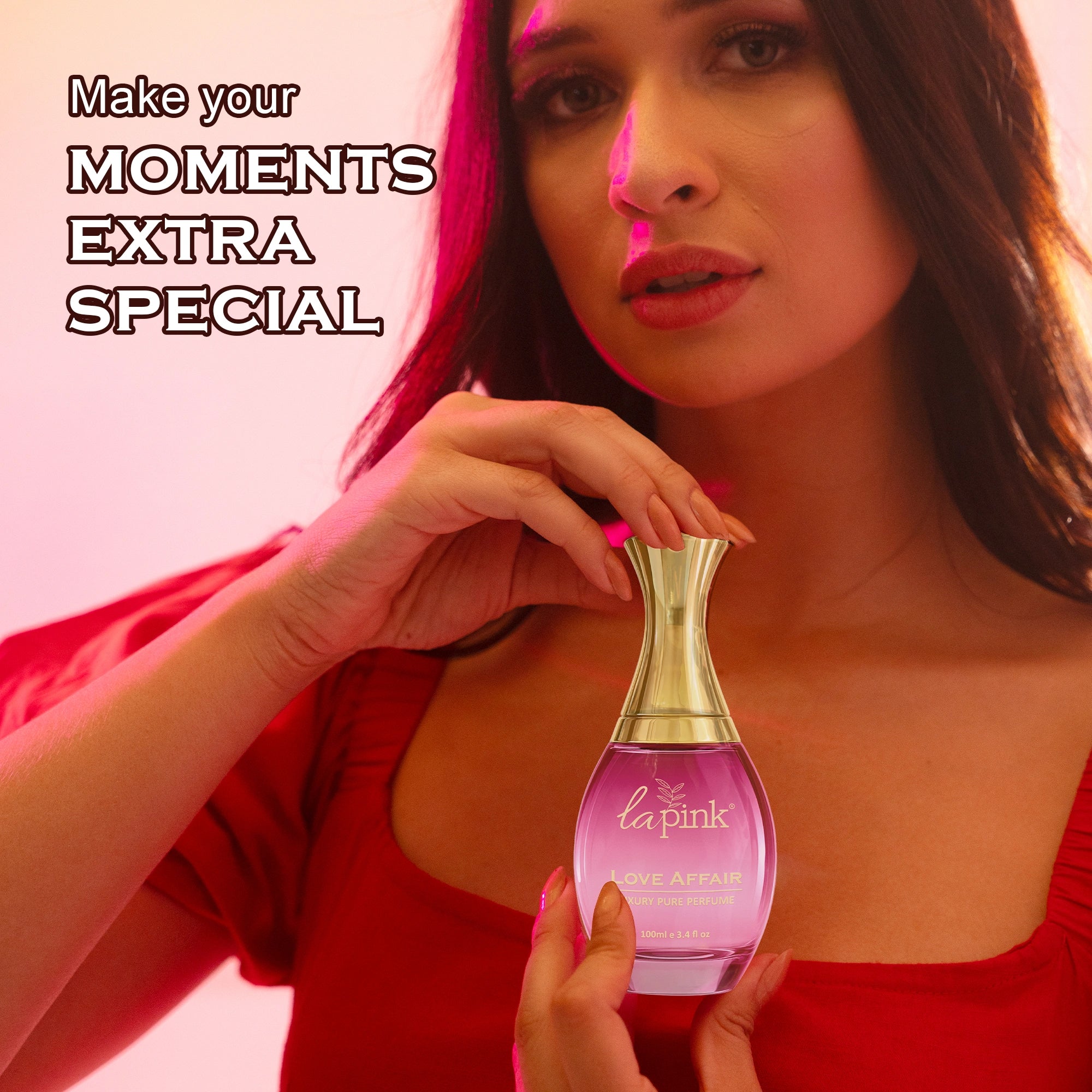 Woman holding a pink perfume bottle with text &