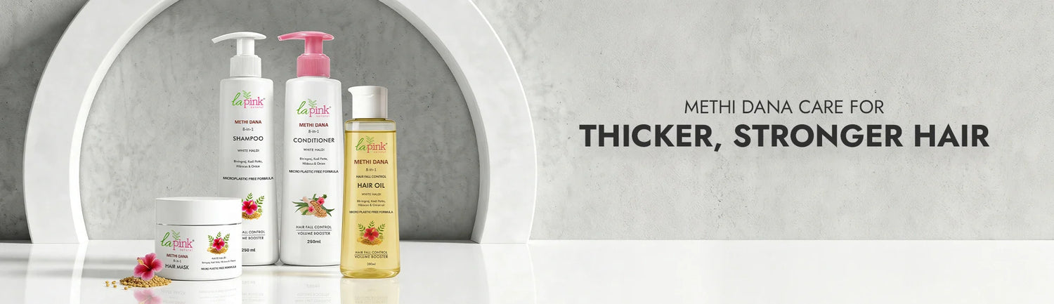 Hair care products with a mirror reflection on a gray background, promoting thicker and stronger hair.