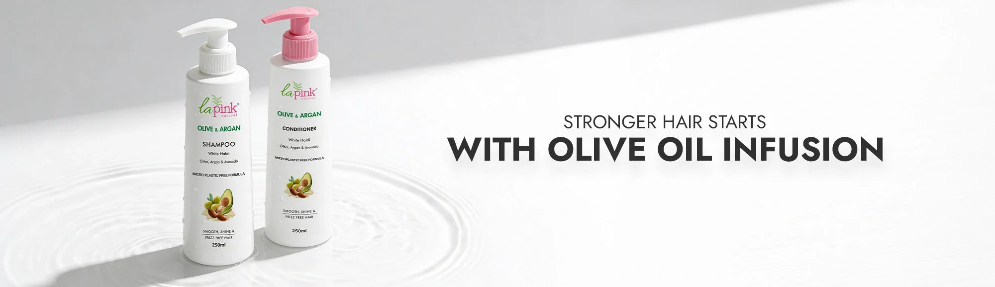 Two bottles of hair care products with olive oil infusion on a white background