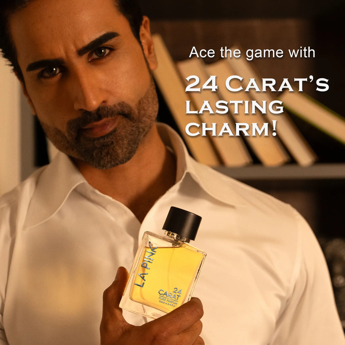 A man in a white shirt holds a bottle of LA&