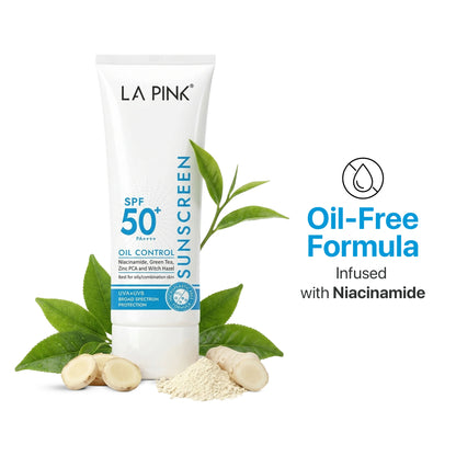 La Pink sunscreen tube with green leaves and ingredients on a white background