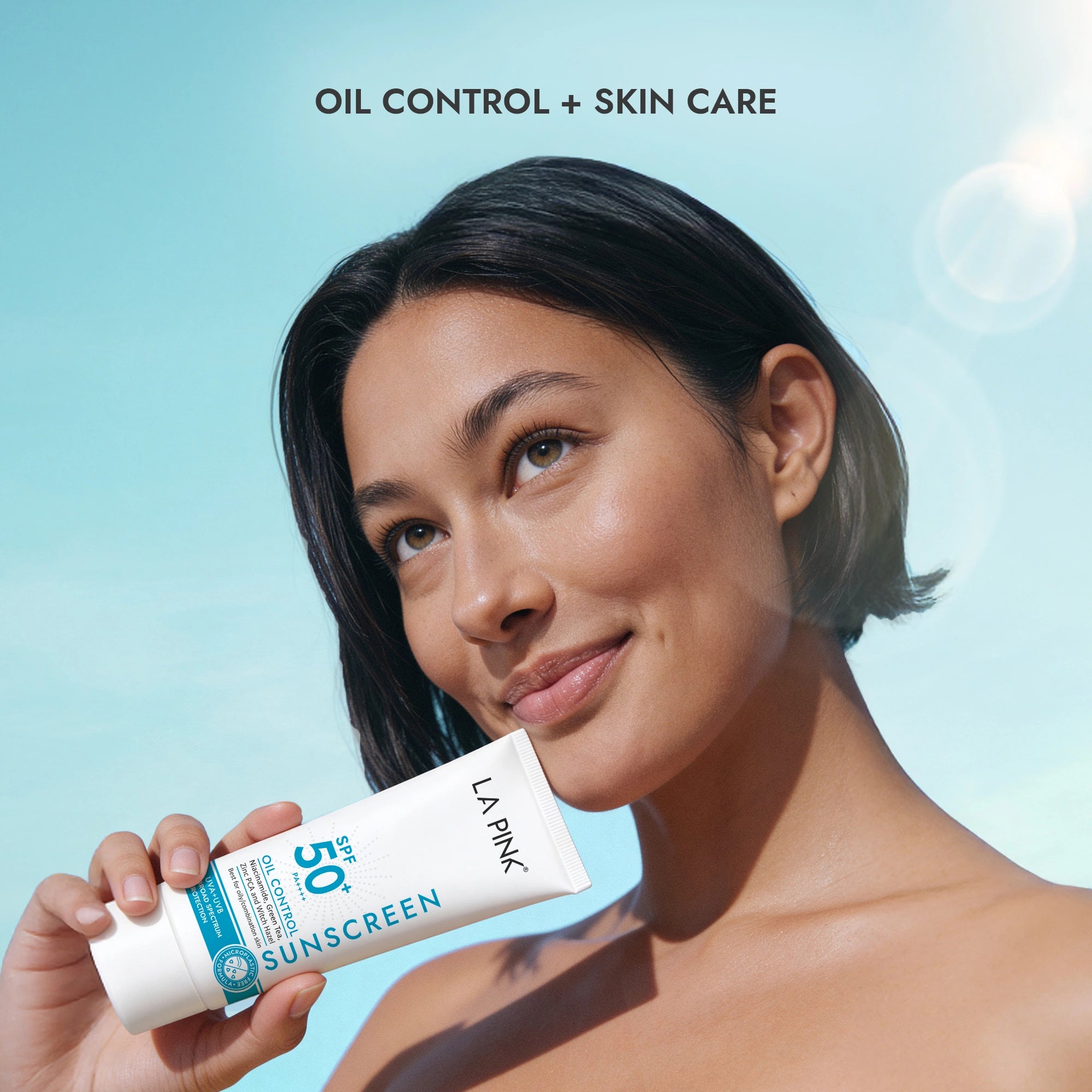 Woman holding a sunscreen tube with &