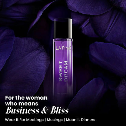 LA PINK Sweet Dream Eau de Parfum bottle in purple glass with a black cap, set against a dark background of purple petals. 