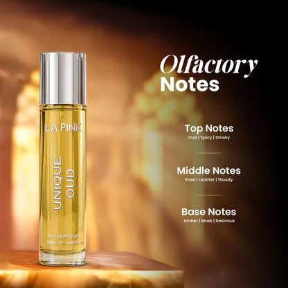 A bottle of LA PINK UNIQUE OUD Eau de Parfum stands on a wooden surface against a warm, glowing background. To the right, text reads &