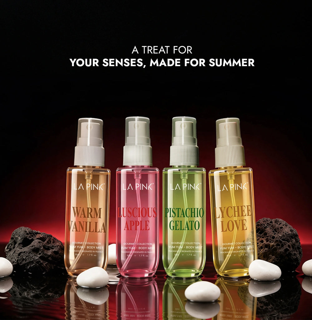 Four bottles of 'La Pink' scented products on a reflective surface with dark background