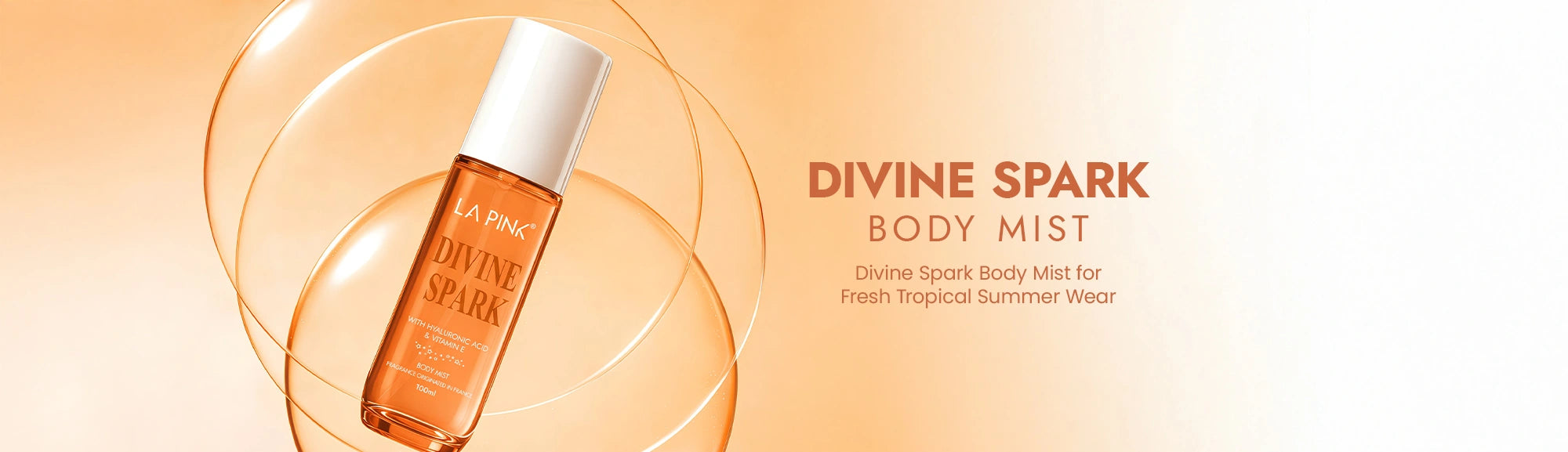 Divine Spark body mist bottle on a warm gradient background