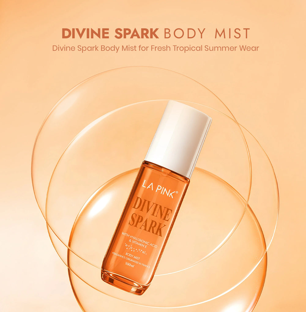 LA Pink Divine Spark body mist bottle on a peach background