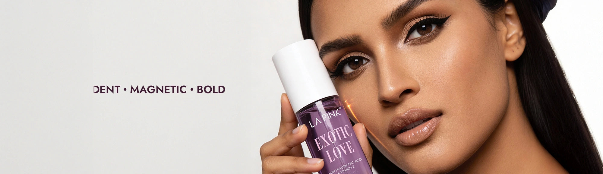 Woman holding a L'Oreal Paris product with text 'Dent Magnetic Bold' on a white background