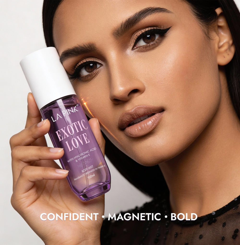 Woman holding a purple bottle labeled 'Exotic Love' by La Pink with text 'Confident, Magnetic, Bold' on a light gray background.
