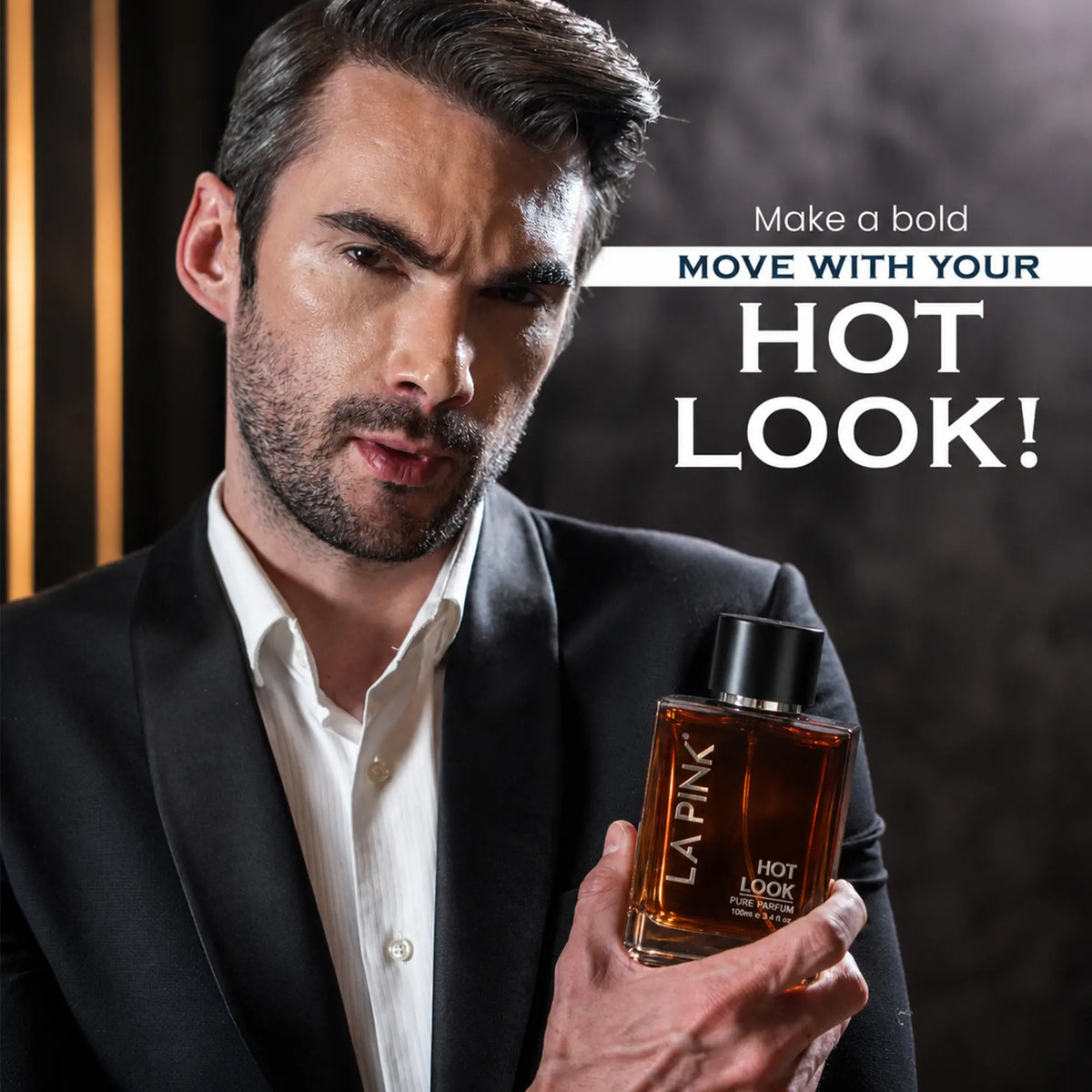 A man in a black suit and white shirt holds a bottle of LA PINK Hot Look fragrance. The image features a dark, moody background with vertical light streaks on the left and bold promotional text on the right.


