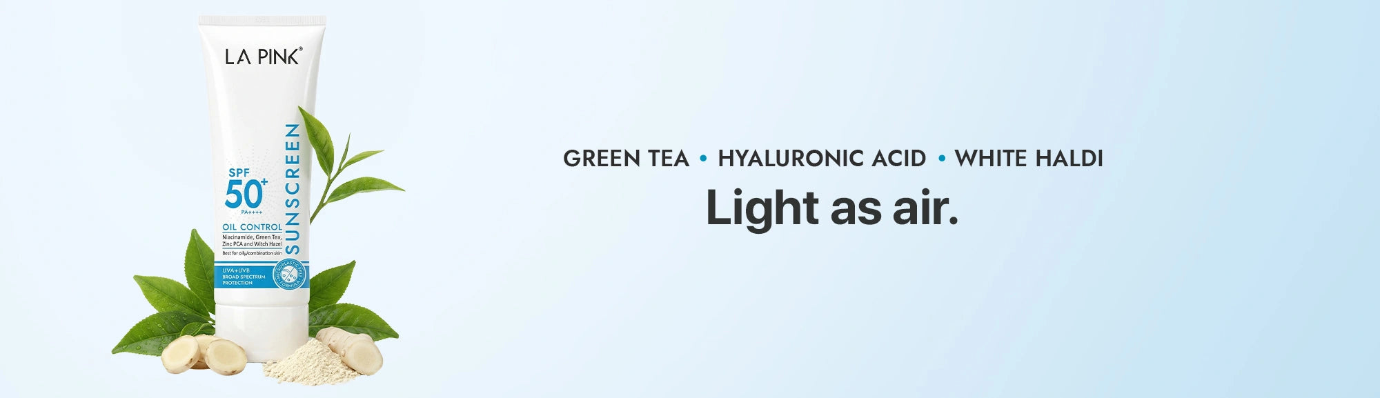 La Roche-Posay sunscreen tube with green tea leaves on a light blue background