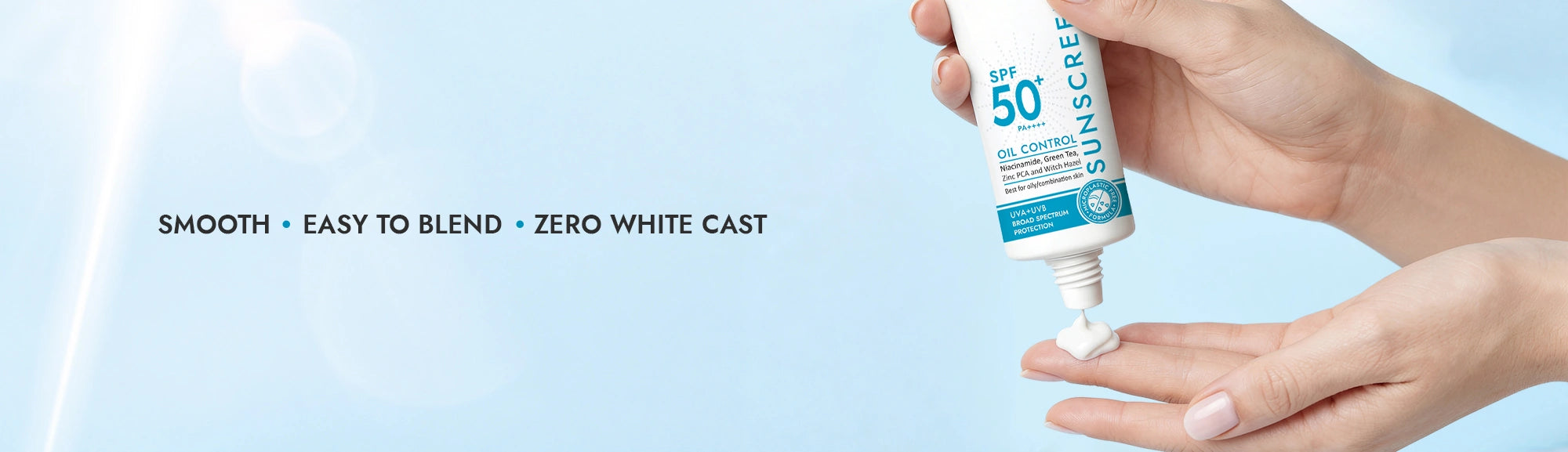 Hand holding a sunscreen tube with text on a light blue background