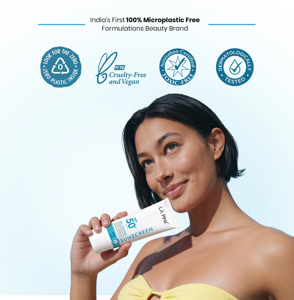 Woman holding a sunscreen tube with branding and certification logos on a light blue background