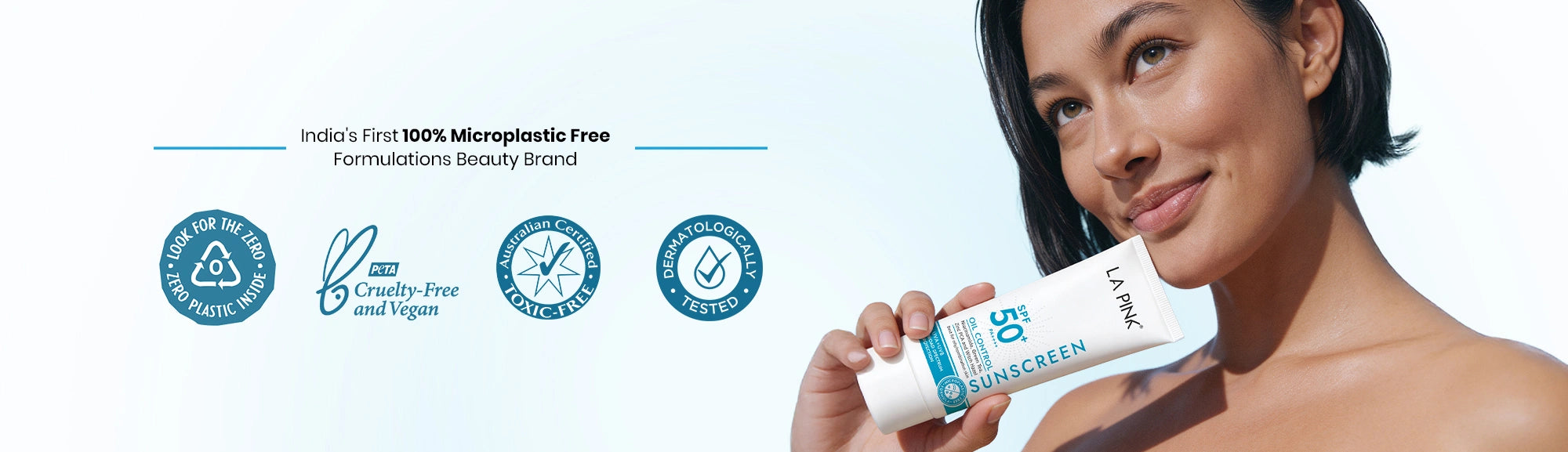 Woman holding a skincare product with branding and certification logos on a light blue background
