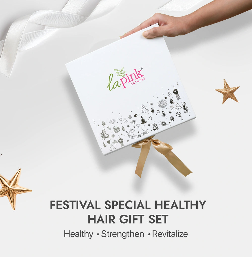 La Pink hair care gift set with decorative elements on a white background