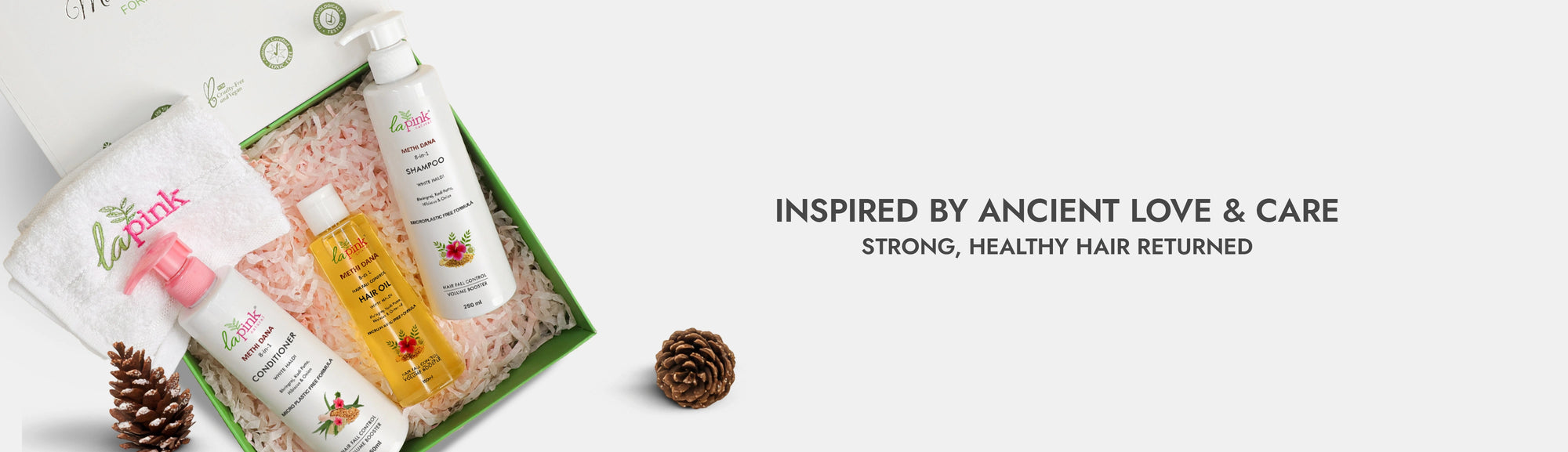 Hair care product set with bottles and packaging on a white background, featuring text 'Inspired by Ancient Love & Care'.