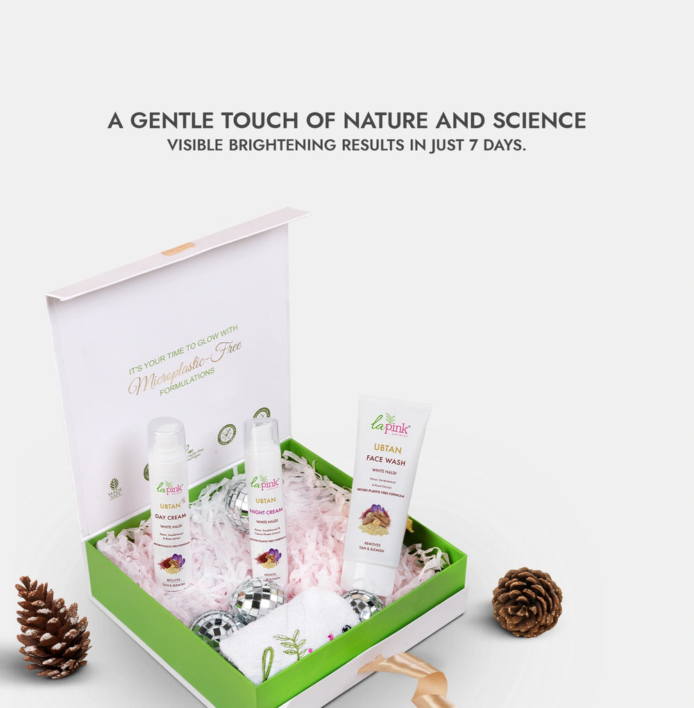 Skincare product set with bottles and a tube in a decorative box on a white background.