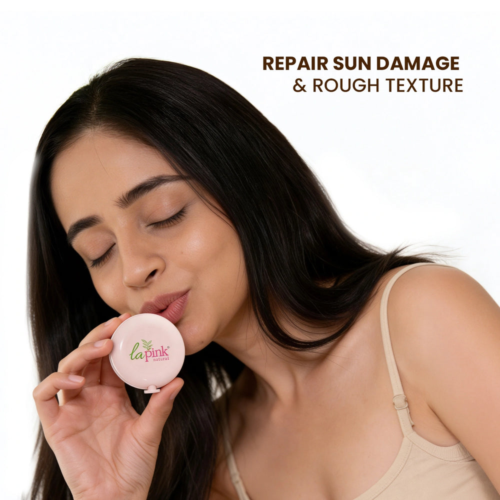 Woman holding a compact mirror with 'la pink' branding, repairing sun damage and rough texture.
