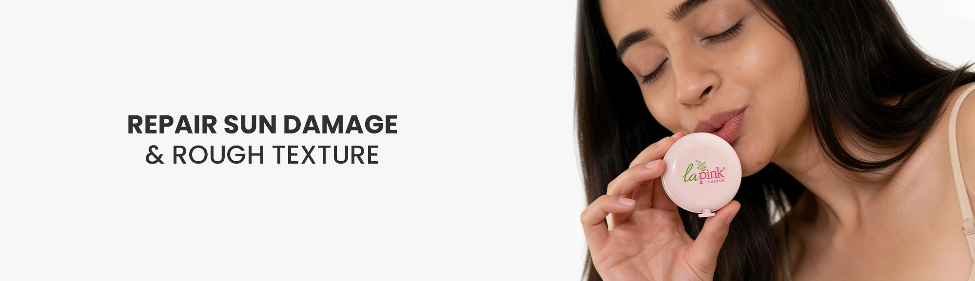 Woman holding a lip balm with text 'Repair Sun Damage & Rough Texture' on a white background