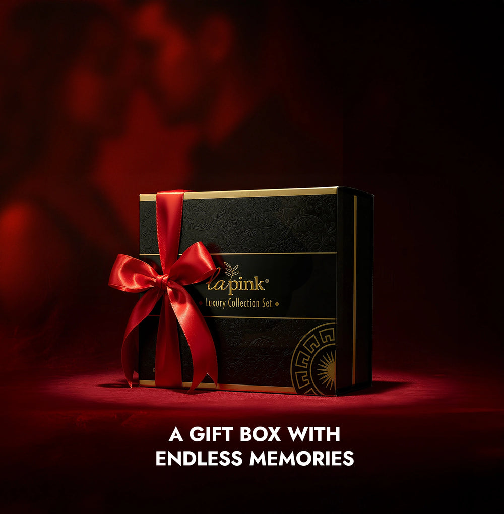Gift box with red ribbon and visible brand logo on a dark background
