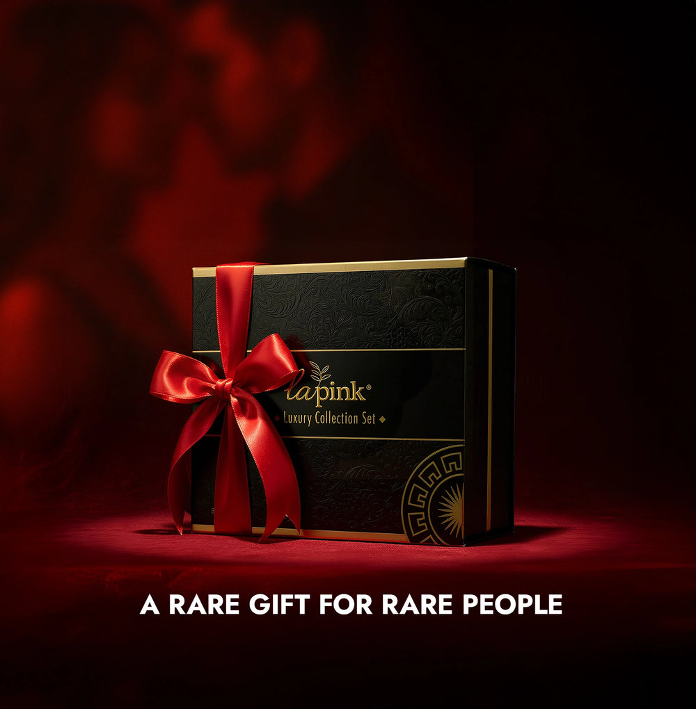 Luxury gift box with a red ribbon on a dark background, featuring the brand 'La Pink'.
