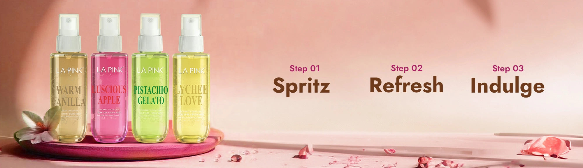 Four spray bottles with different scents on a pink background