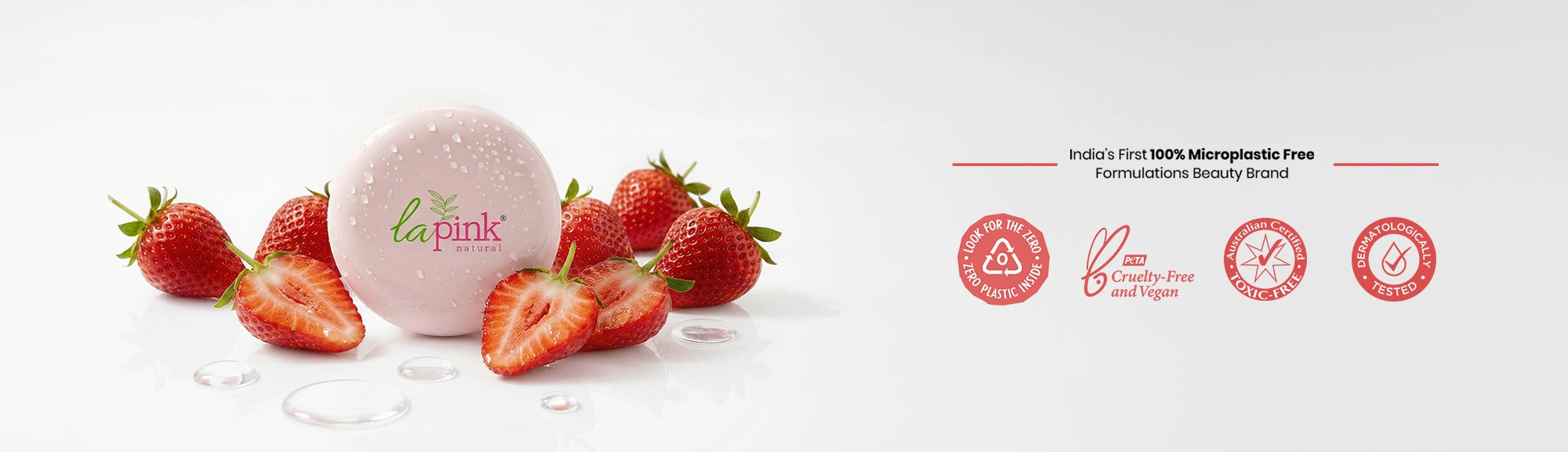 La Pink product with strawberries on a white background