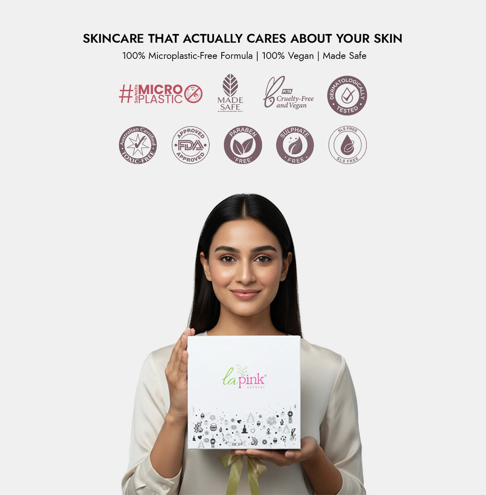 Woman holding a skincare product box with brand name 'la pink' on a white background.