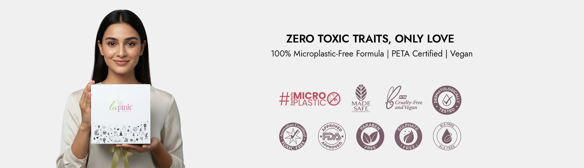 Woman holding a product box with certifications on a white background