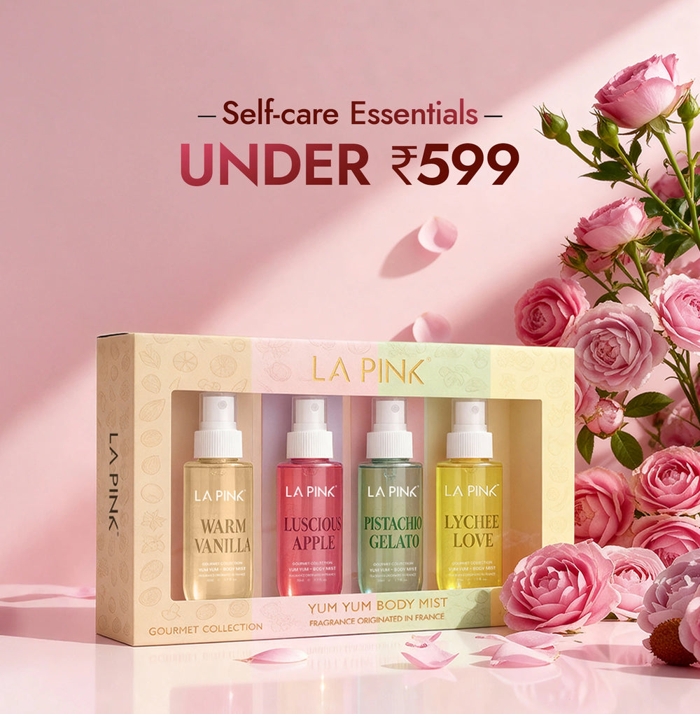 LA Pink self-care essentials set with four bottles and a box, surrounded by pink roses on a pink background.
