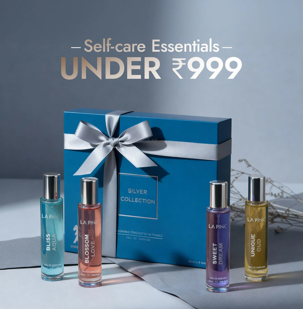 Set of perfume bottles with a blue gift box on a gray background, labeled 'Self-care Essentials Under ₹999'.