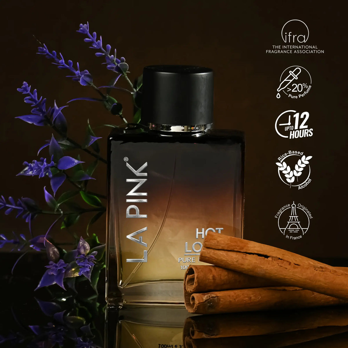 LA PINK Hot Love Pure Spice cologne bottle with a black cap, set against a dark brown background with purple flowers and cinnamon sticks. Certification badges from IFRA are displayed on the right.


